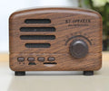 Compact portable Bluetooth speaker with a vintage wood grain finish on a plastic shell