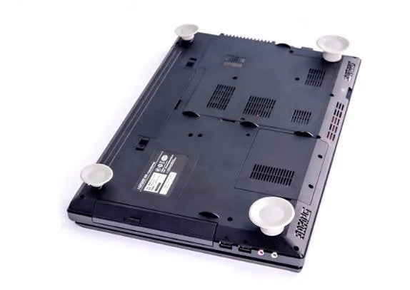 Grey durable plastic laptop cooling pads, two large and two small, on a table.