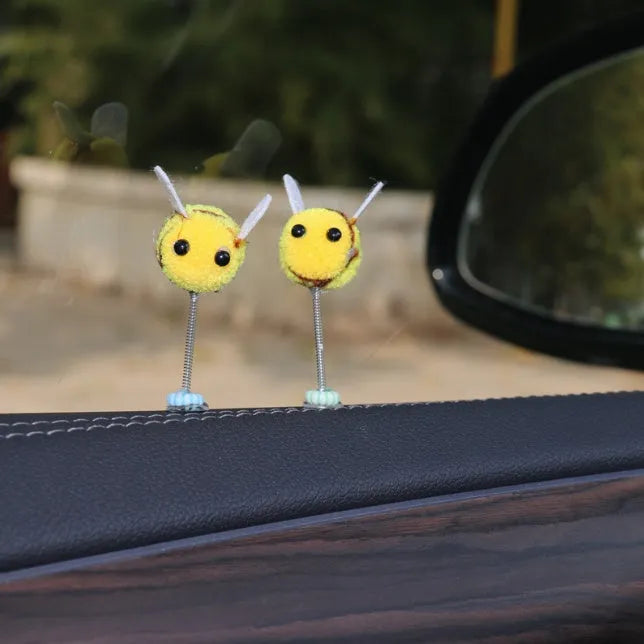 Swing Spring Bee soft fur ball car decoration with cartoon bee shape on adhesive backing.