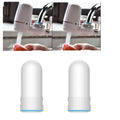 White plastic faucet water filter with switch lever and ceramic cartridge, shown with universal tap adapters.