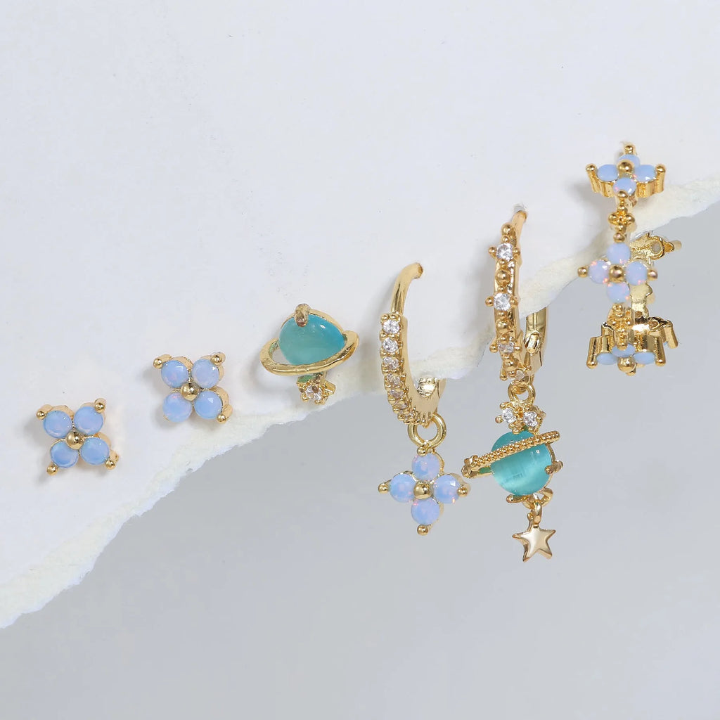 Gold and silver Japanese Korean style stud earrings with blue flower nail shape and zircon mosaic detail.