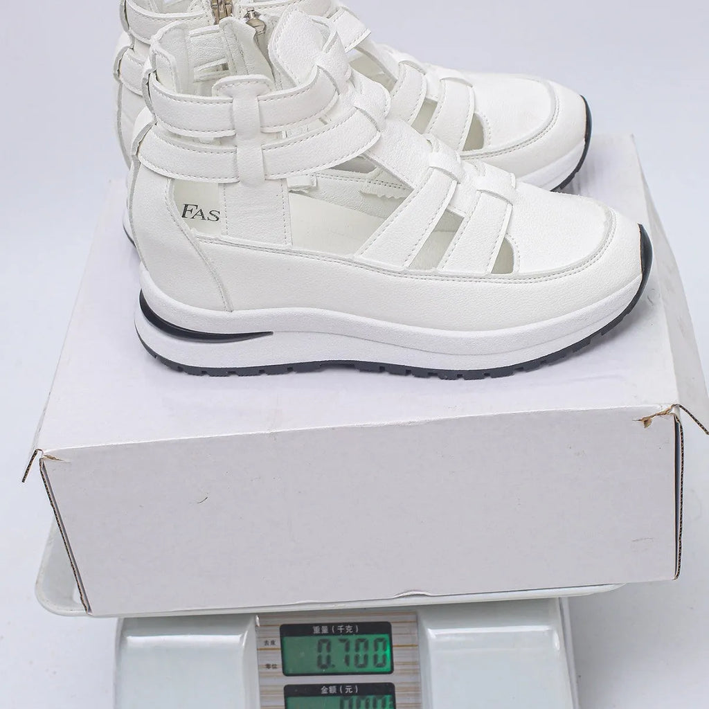 Black women's close-toed platform sandals with hollow-out design and Velcro strap on a white background.