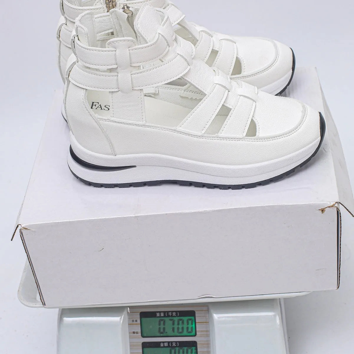 Black women's close-toed platform sandals with hollow-out design and Velcro strap on a white background.