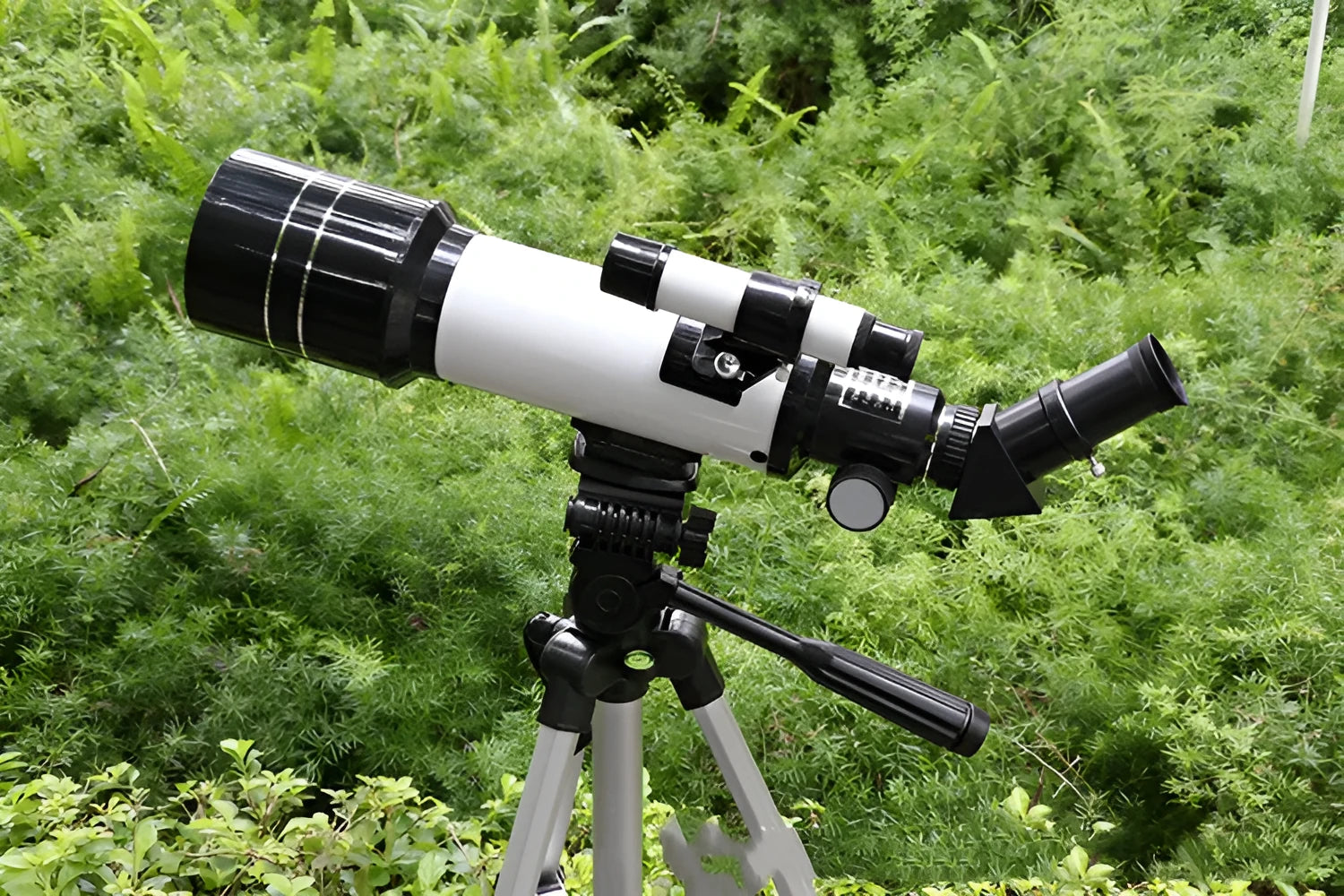 Dark blue children's monocular astronomical telescope with tripod on a table.