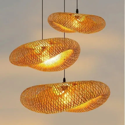 Natural bamboo straw hat-shaped pendant lamp shade hanging from a ceiling, showing its woven texture.