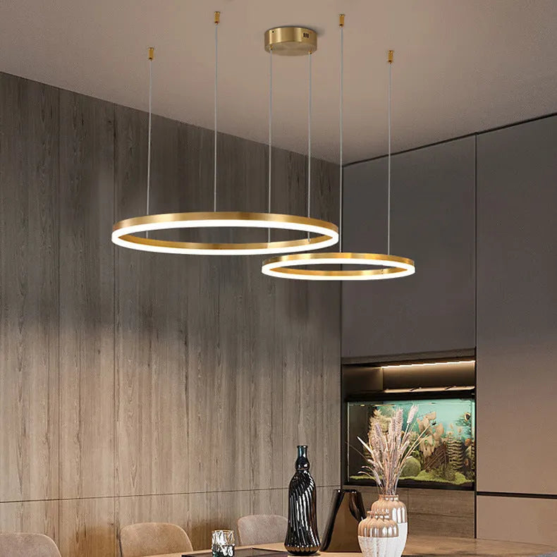 Modern copper circle chandelier with acrylic elements in a Nordic light luxury style for a living room.