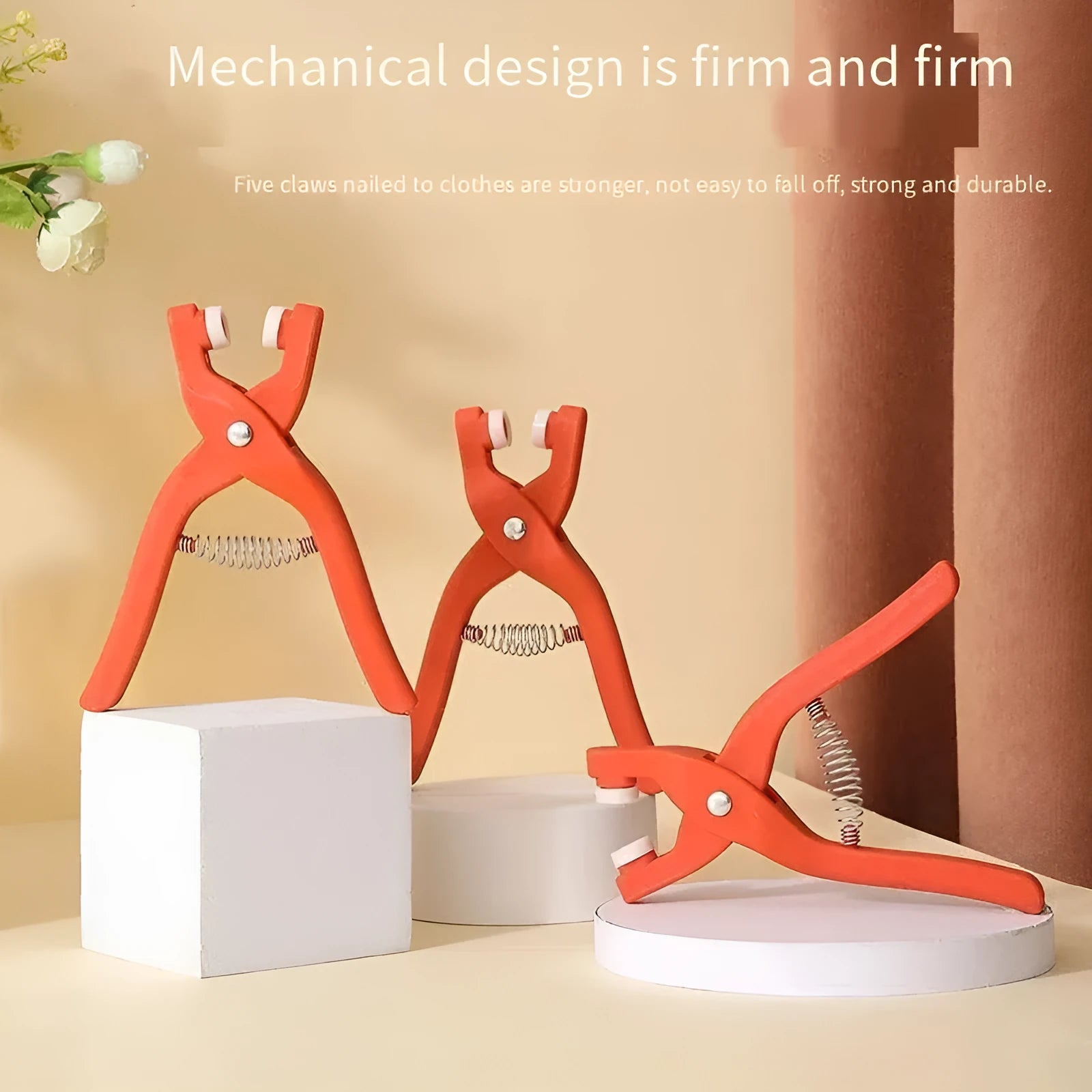 Stainless steel five-claw no-sew buttons and application pliers for children's clothing.