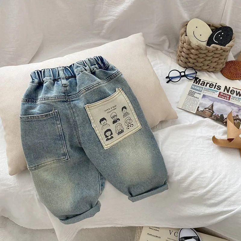 Light-coloured boys denim jeans with printed back pocket and elastic waist, front view