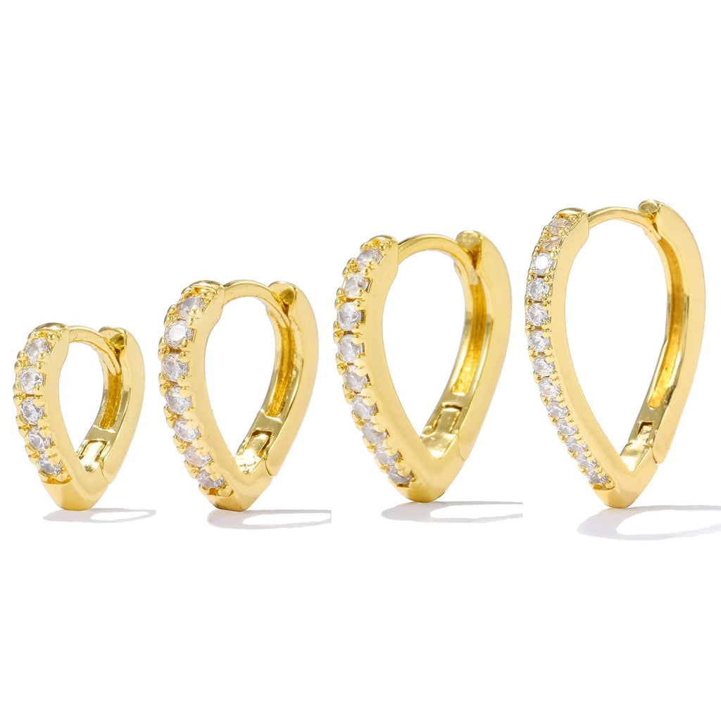 A geometric heart-shaped ear clip in a gold electroplated finish on a copper base.