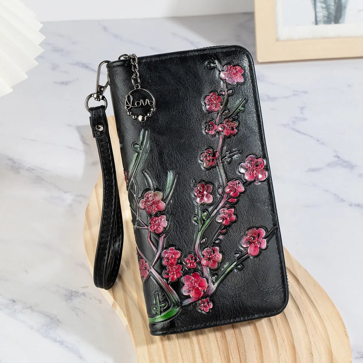 Embossed floral handbag with retro styling and zipper closure