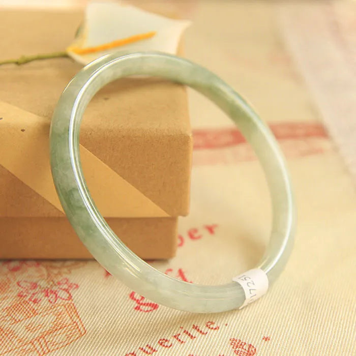 Green jade waxy finish geometric Chinese style bracelet shown on wrist, 10mm width.