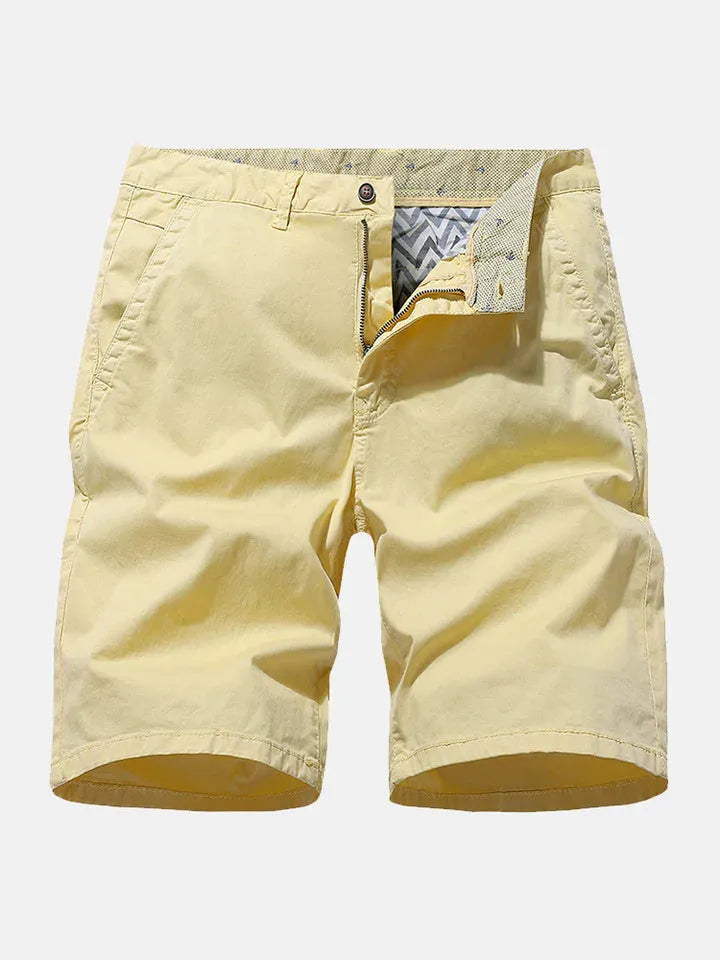 Men's loose-fit denim work shorts in blue, shown in a casual setting.