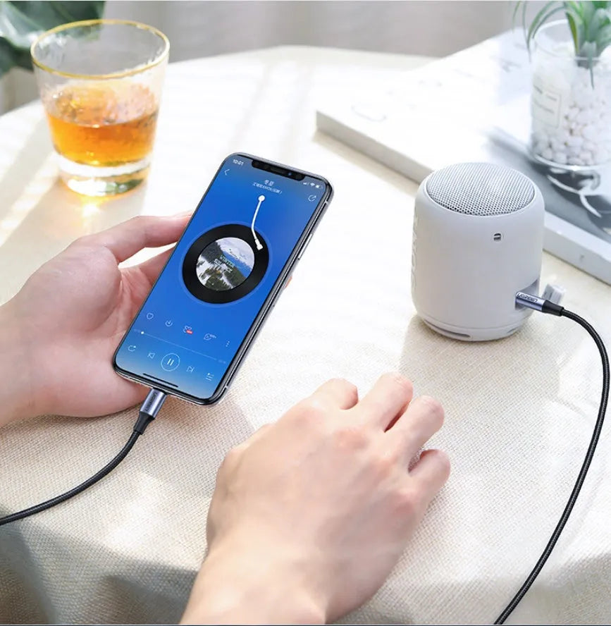 Black Apple Lightning to 3.5mm audio cable with shiny braided finish and aluminum connectors for car use.