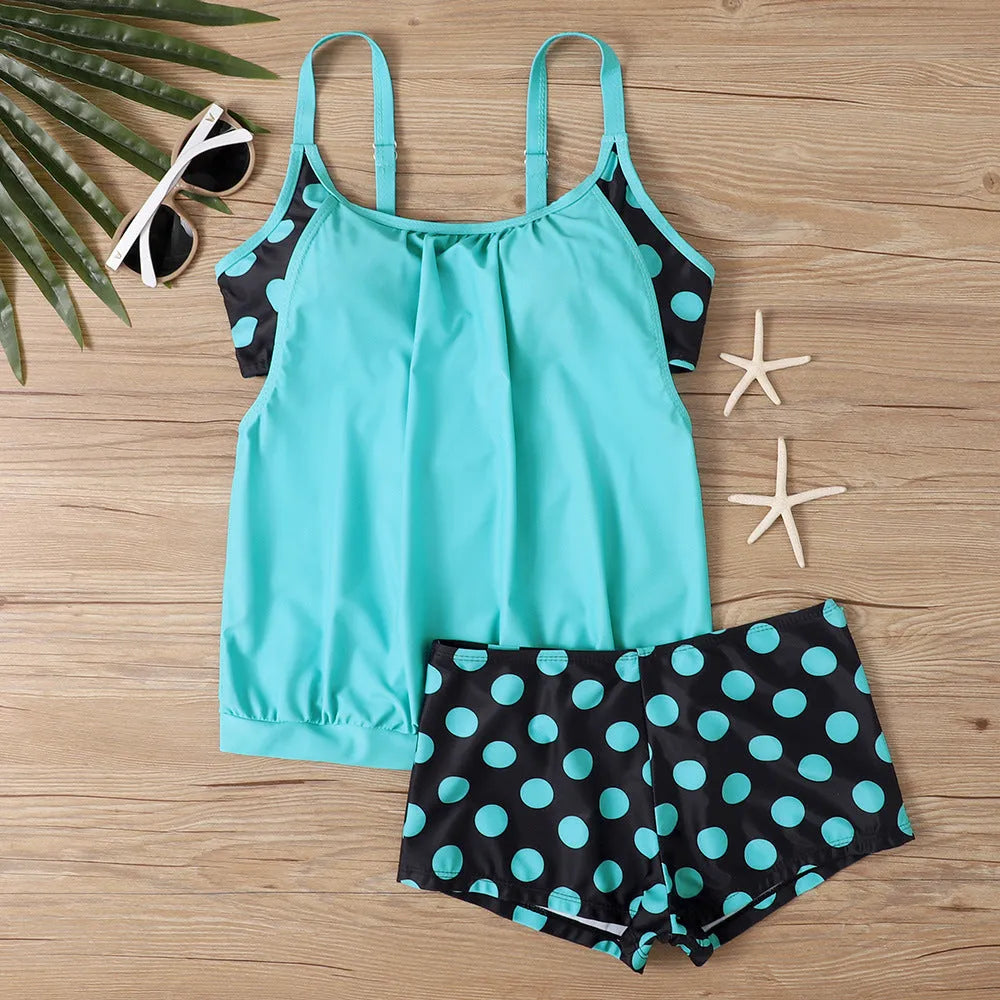 Women's black polka dot high-waist boxer swimsuit set on a mannequin