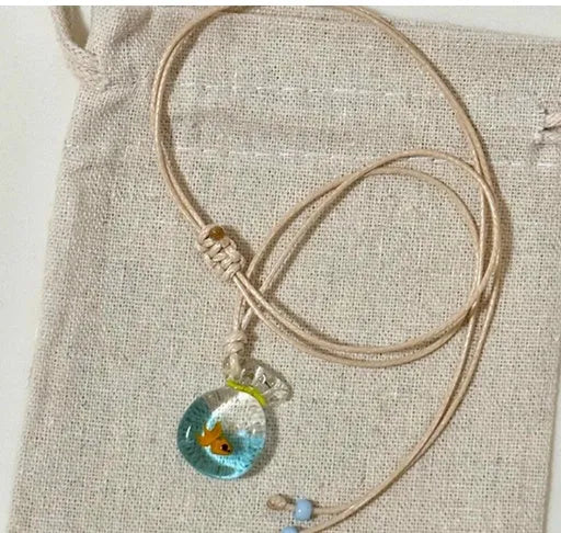 Women's world style necklace with coloured glaze joker pendant on a cotton linen clavicle chain.