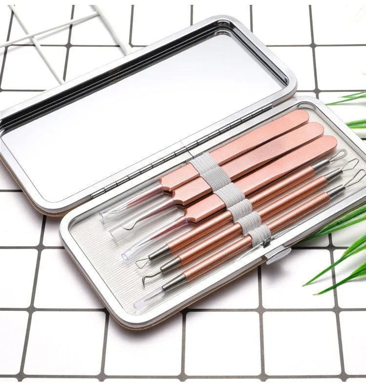 Six rose gold stainless steel acne removal tools arranged in set for facial pimple extraction