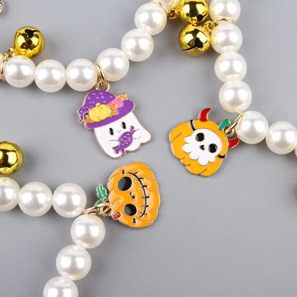 Halloween cat collar with simulated pearl necklace decoration showing pumpkin designs including purple ghost, skull, and smiling pumpkin patterns