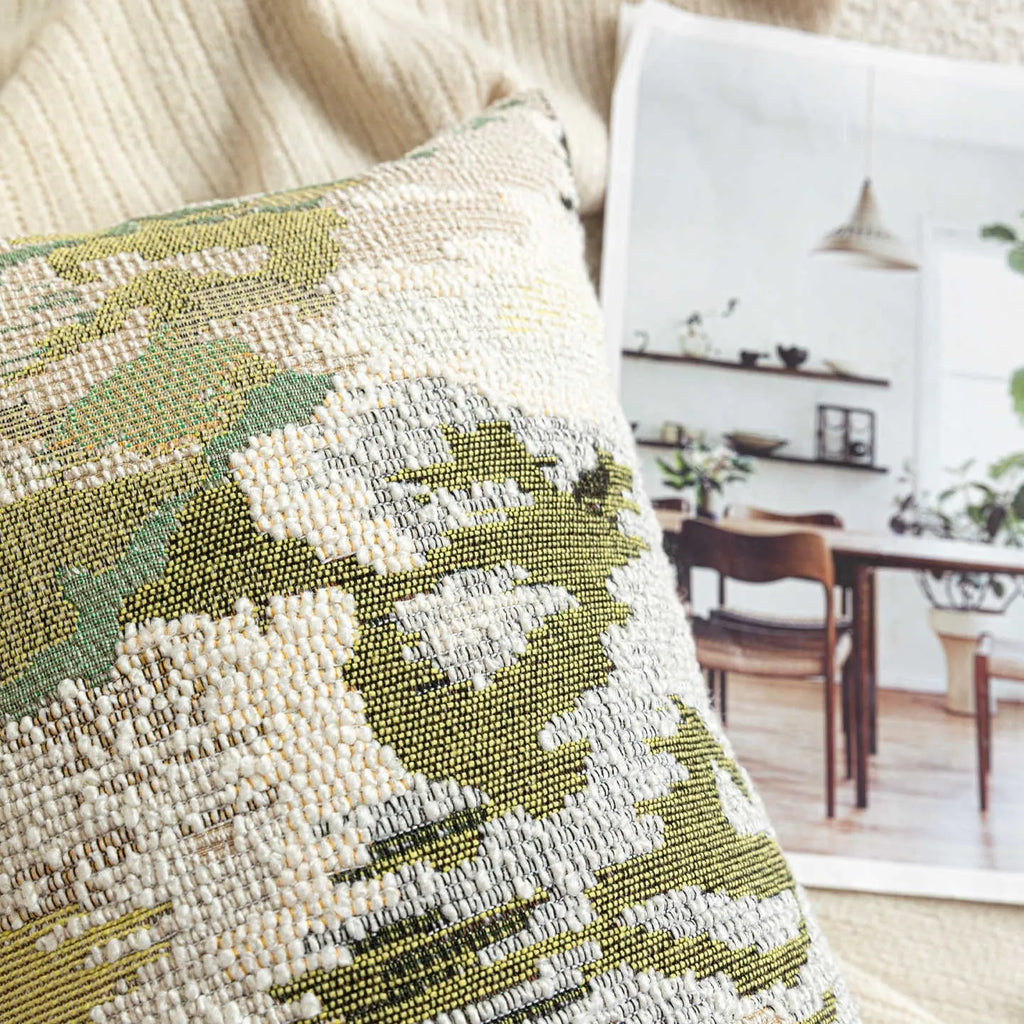 Green wool blend cushion cover with a spring flowers botanical pattern, shown in square and lumbar sizes.