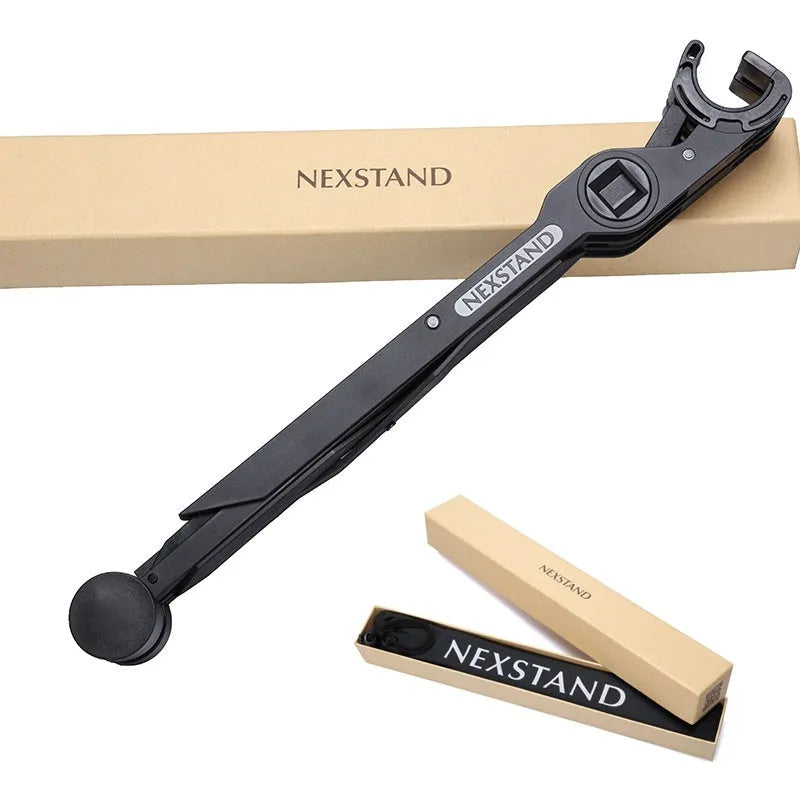 Sagacious black portable folding laptop stand bracket on a desk next to a laptop.