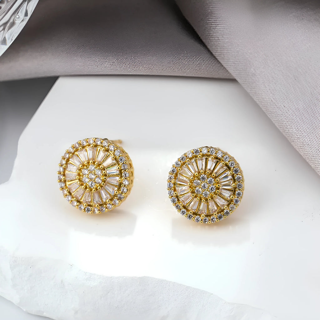 Geometric gold electroplated earrings with a round pattern design.
