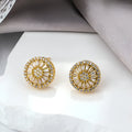 Geometric gold electroplated earrings with a round pattern design.