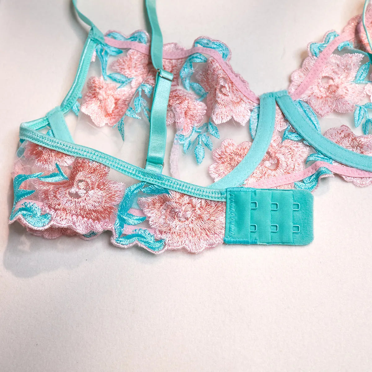 Pink women's mesh pettiskirt and bikini set with embroidery detail.