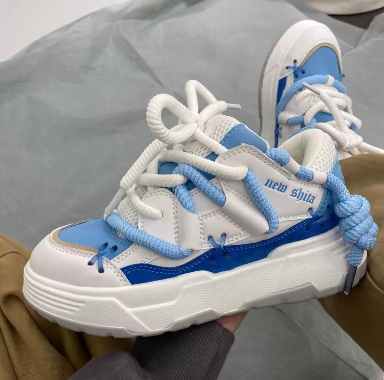 Women's grey retro chunky sneakers with thick rubber platform sole and lace-up front.