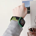 Two-tone silicone protective case for Apple Watch in black and white, fitted on a watch face