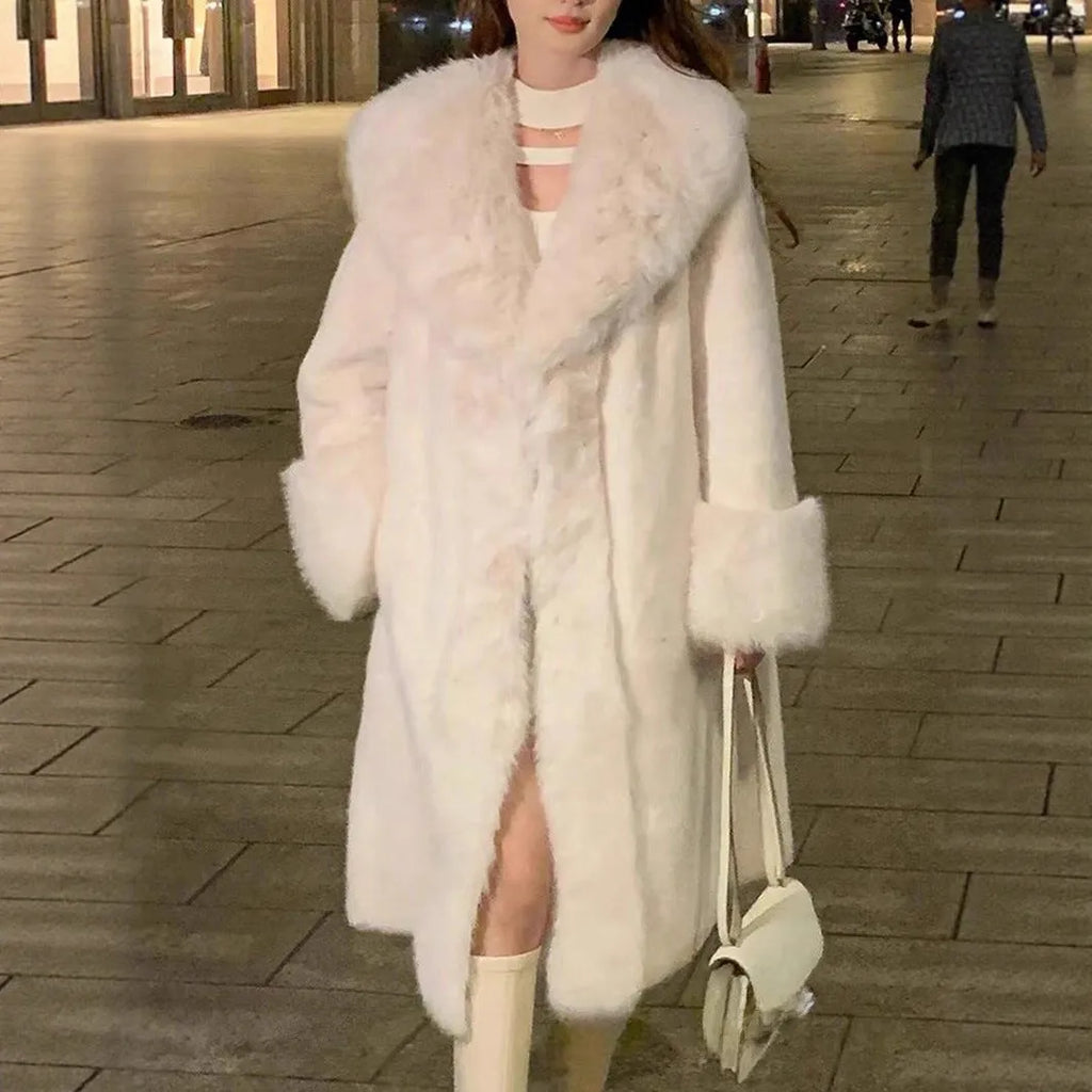 Grey women's thick faux rabbit fur mid-length coat with a fur collar on a hanger.