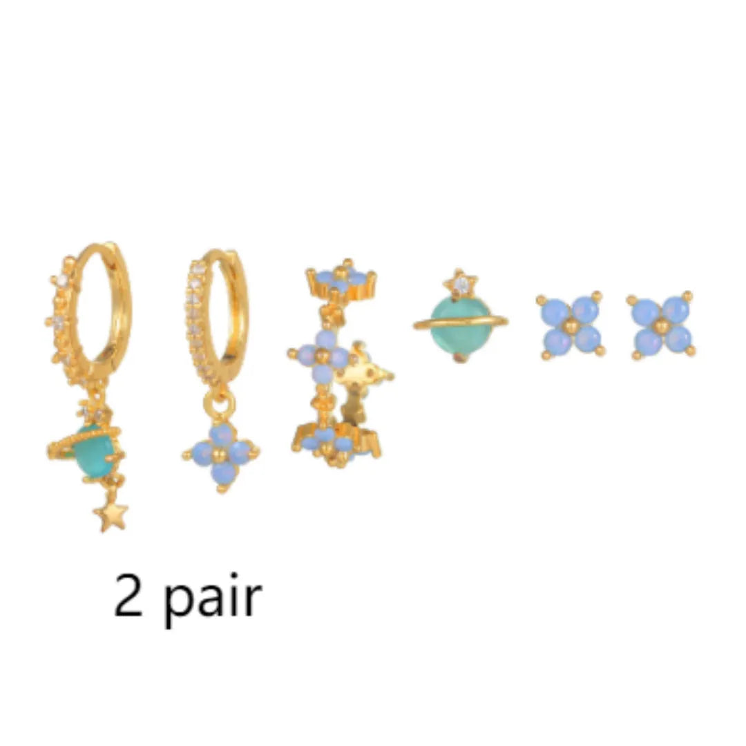 Gold and silver Japanese Korean style stud earrings with blue flower nail shape and zircon mosaic detail.