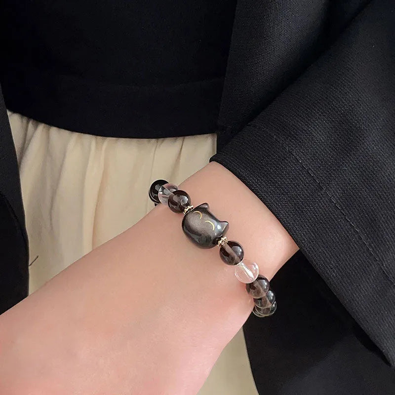 Close-up of women's silver bracelet with 8mm opal ice stone and cat head charm.