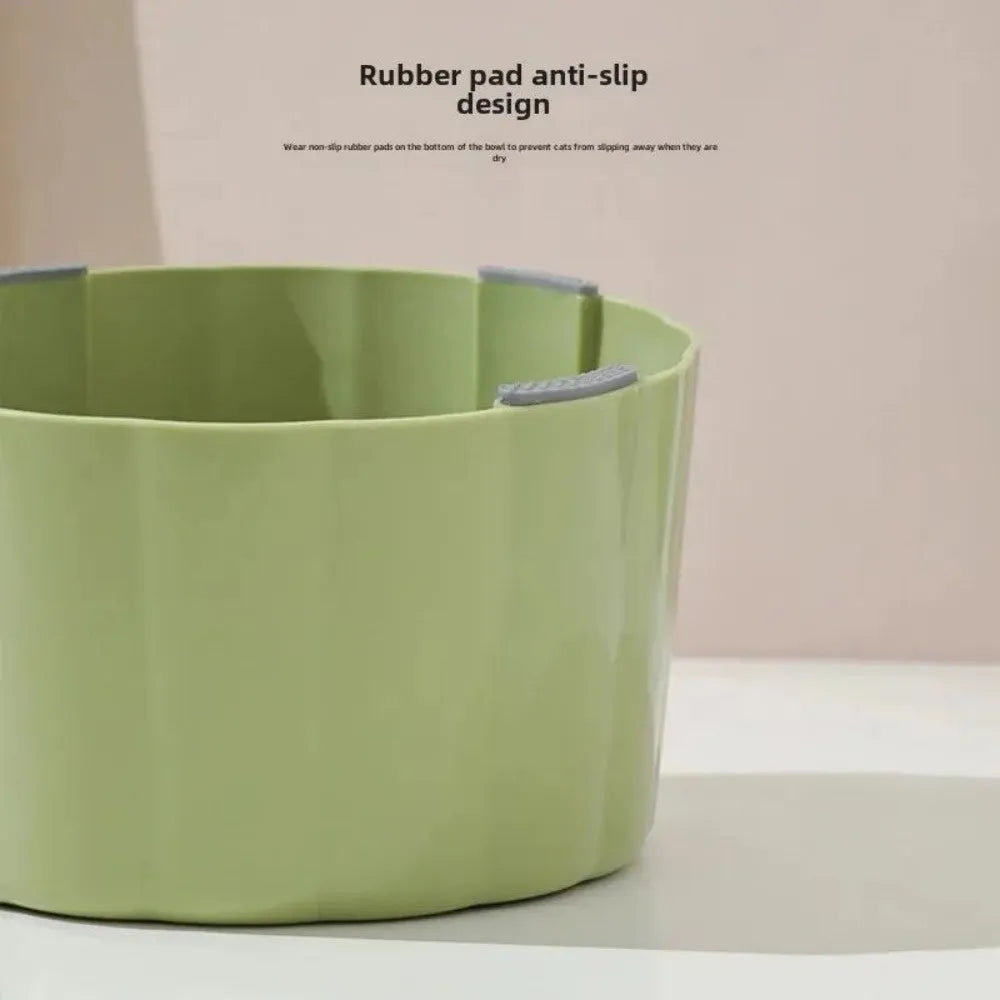 Dark green cat bowl with cactus design and anti-slip base on a wooden surface.