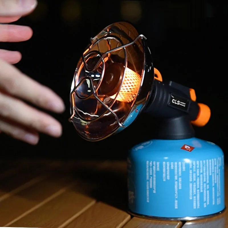Black and orange portable gas heating stove for camping with automatic ignition.