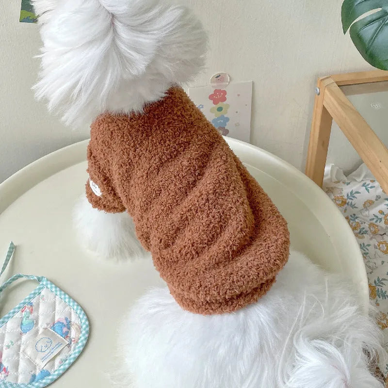 Reversible brown cloud velvet dog jacket shown on a small dog, illustrating the fluffy texture and fit.