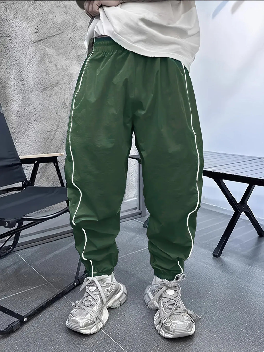 Man wearing loose, cropped blue bamboo fibre casual trousers.