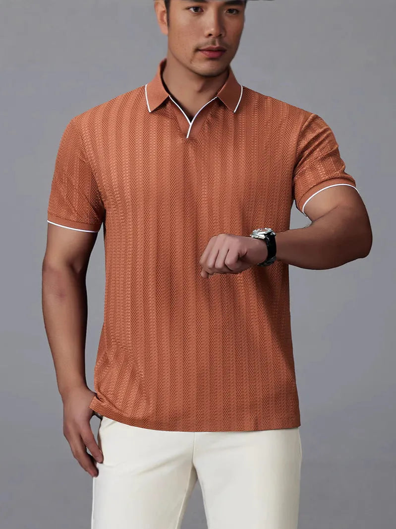 Man wearing a loose-fit black nylon polo shirt, short sleeves, casual style.