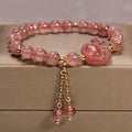 Women's multi-layer crystal bracelet with natural garnet, strawberry quartz pendants, and jinsi jade beads in assorted colours.
