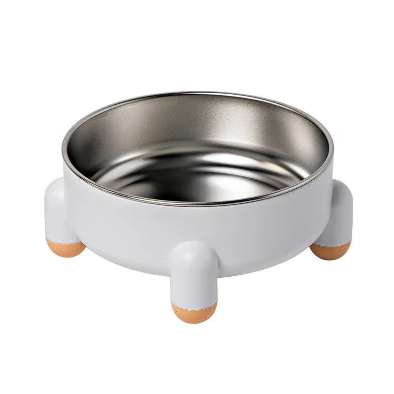 A green stainless steel pet bowl with a non-slip base and high foot, placed on a floor.