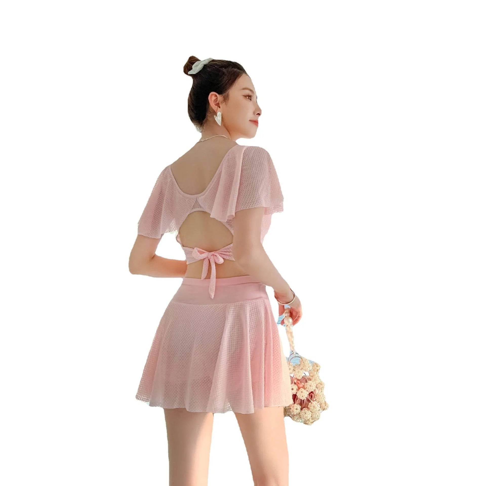 Women's solid colour two-piece swimsuit set with a top and split skirt.