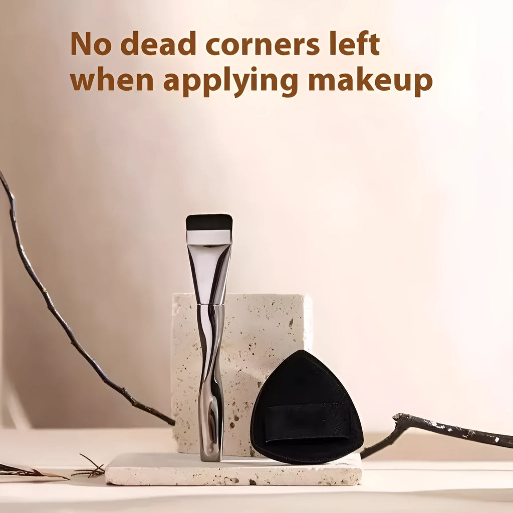 Spiral-shaped black powder foundation brush with long handle and puff on a pineapple-print box.