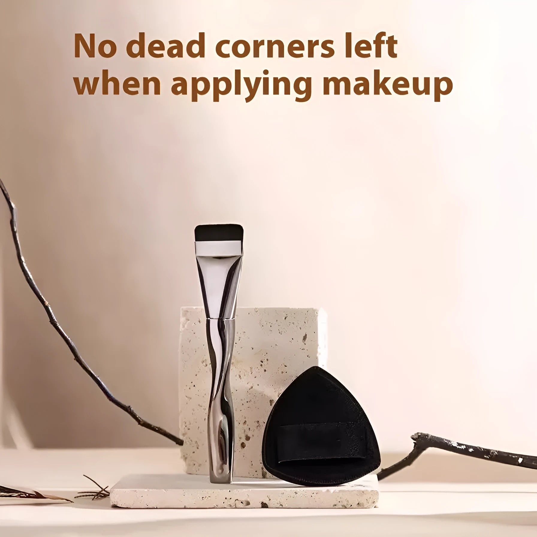Spiral-shaped black powder foundation brush with long handle and puff on a pineapple-print box.