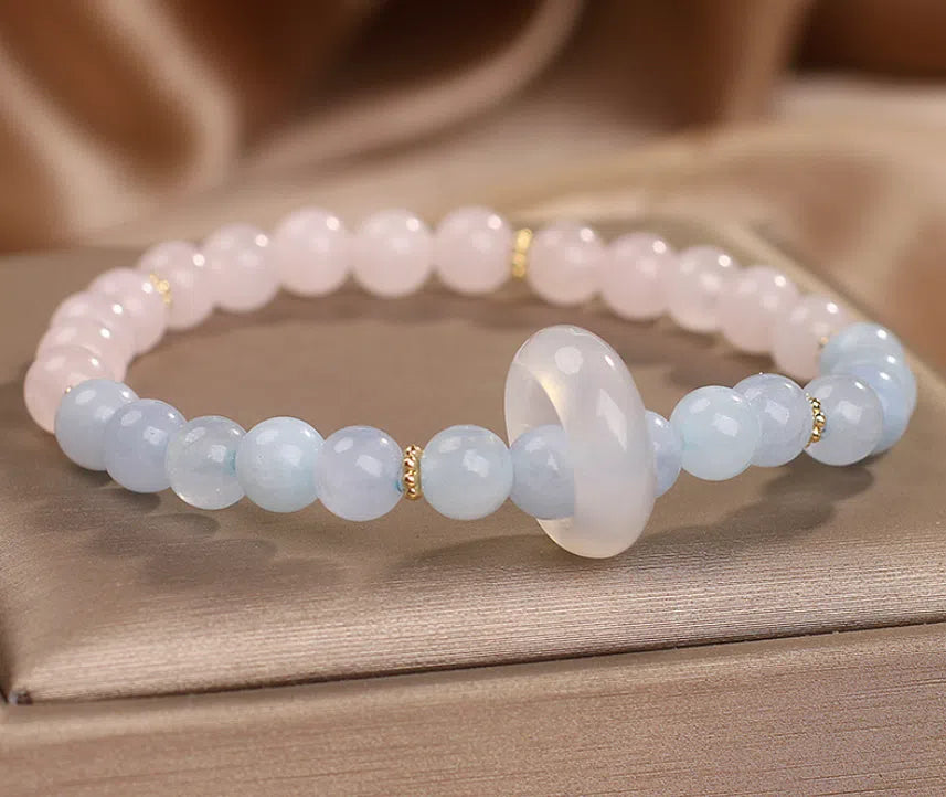Natural aquamarine crystal beaded bracelet with pink electroplated finish on display