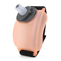 Orange wrist water bottle with Velcro strap shown secured around wrist during running activity