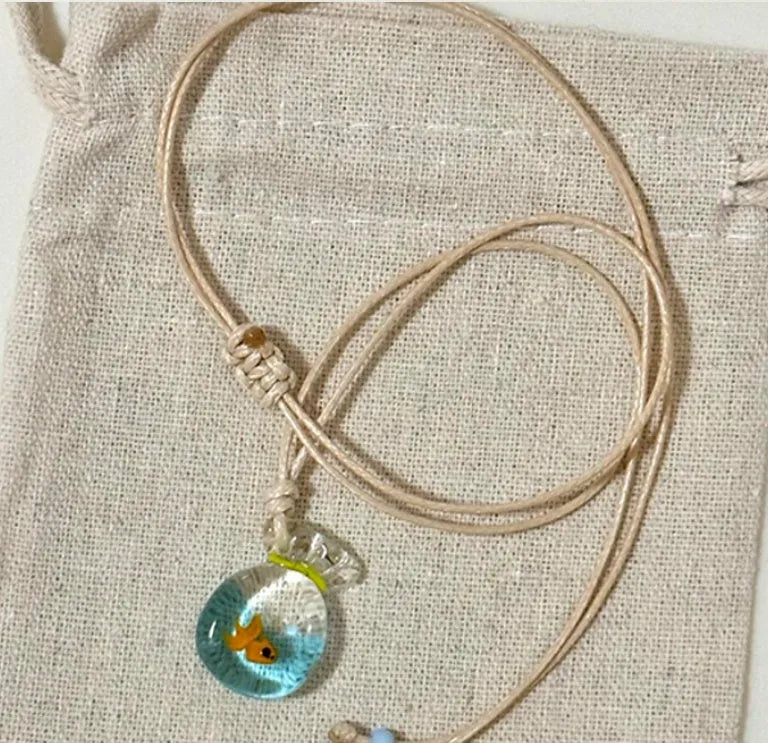 Women's world style necklace with coloured glaze joker pendant on a cotton linen clavicle chain.