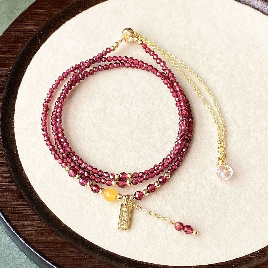 Wine red garnet bracelet with three circle design showing 2.5mm cut stone beads and electroplated metal