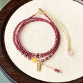 Wine red garnet bracelet with three circle design showing 2.5mm cut stone beads and electroplated metal