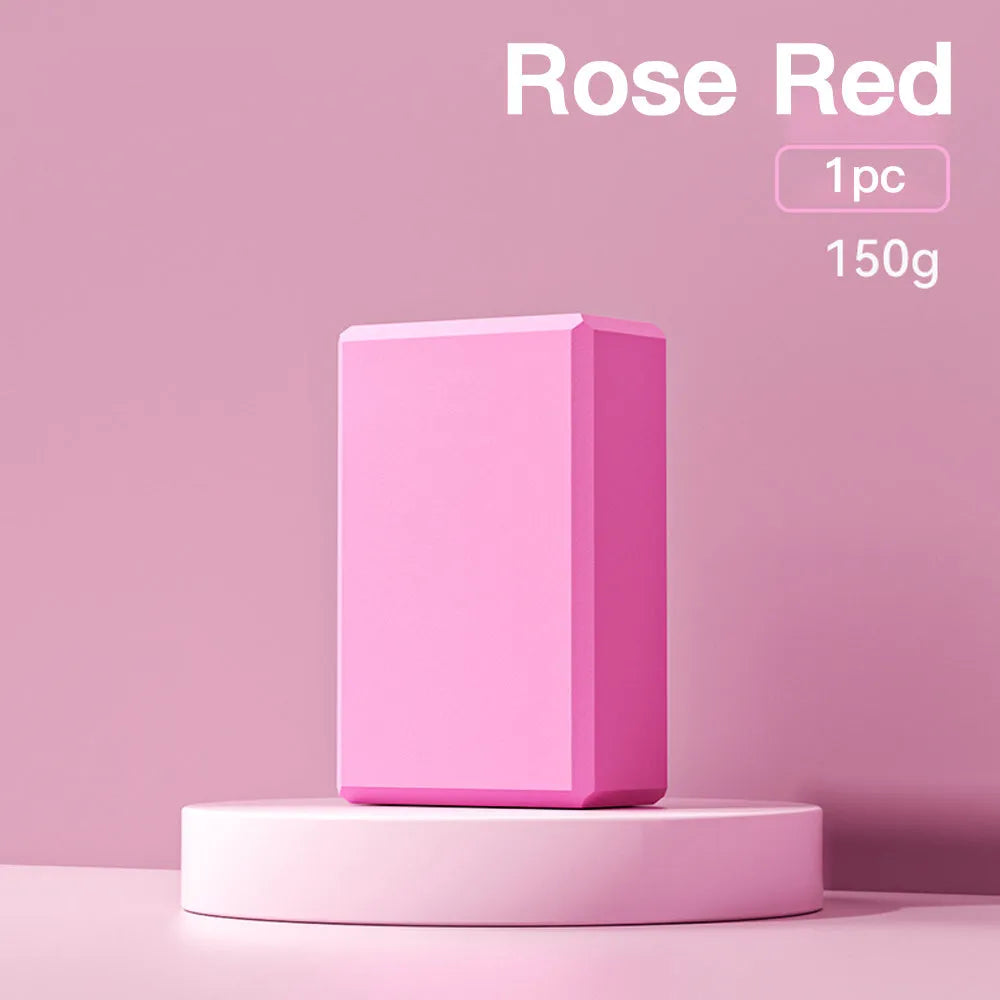 Solid colour EVA foam yoga block measuring 23cm long on a workout mat.