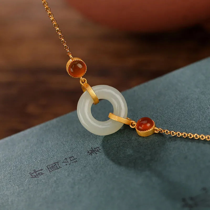 Gold-plated S925 sterling silver bracelet with inlaid natural Hetian jade stone and adjustable peace buckle clasp.