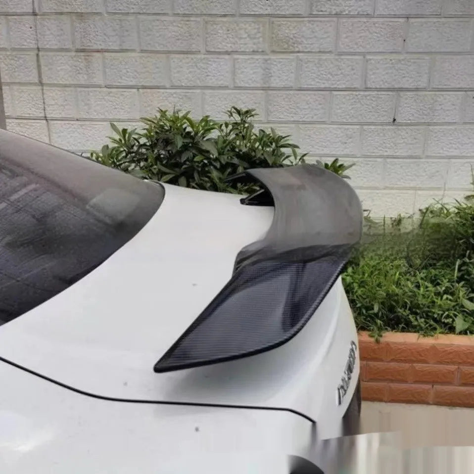 Universal punch-free car spoiler tail wing in ABS plastic on a vehicle.