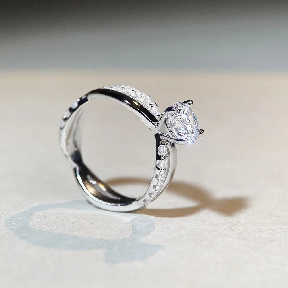 Geometric twisted silver band ring with 1 karat moissanite stone in four-claw setting, side view showing cross details